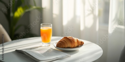 A cozy breakfast scene features a croissant and a glass of orange juice on a light table. Perfect for morning routines. The style is bright and inviting. This image captures simplicity. AI