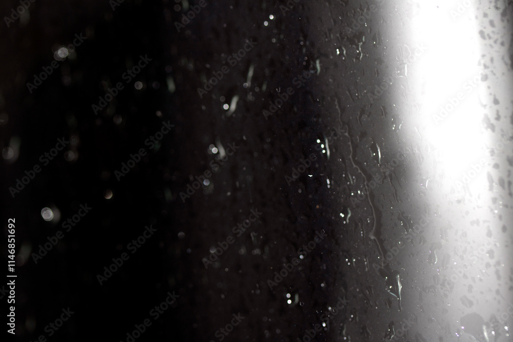 Obraz premium Close Up of Heavy Rain Floating Liquid Water Bubbles and Drips Black Background