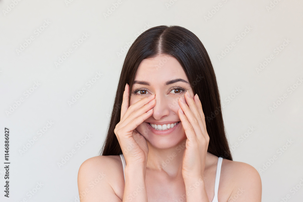 Young pretty brunette woman shying, looking at camera, covering her face with her hands and smiling. Young pretty brunette woman shying, looking at camera, covering her face with her hands and smiling.