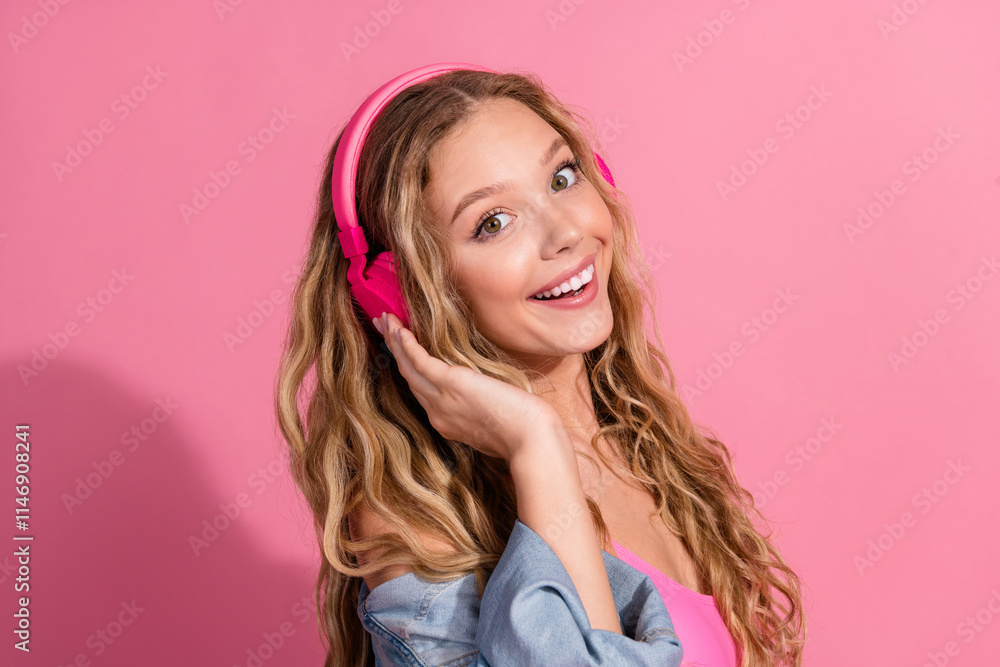 Beautiful young woman with blonde hair enjoying music on pink background Beautiful young woman with blonde hair enjoying music on pink background