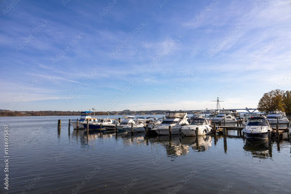 Fototapeta premium Picturesque view of Alexandria Marina beside the ferry dock from Washington, DC, featuring boats and serene waterfront surroundings.