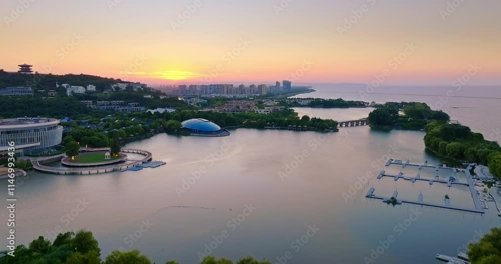 Modern city buildings at bay pier at sunset in Huzhou, China Modern city buildings at bay pier at sunset in Huzhou, China