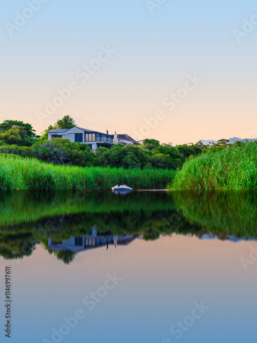 Obraz na płótnie Scenic view of houses along the riverbank with water reflections in Stanford, Western Cape, South Africa w salonie