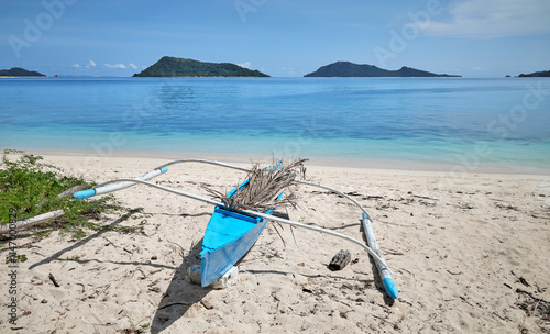 Bangka fishing boat on the beach of Inapupan Island in the Philippines. photo