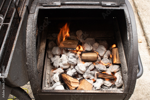Charcoal with fire ready to cook food in a small grill