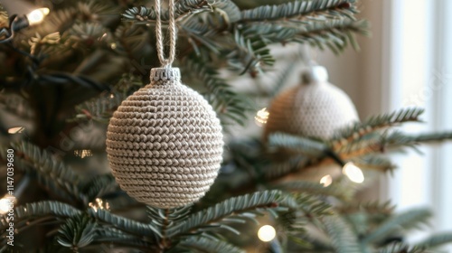 A beige crocheted Christmas ball ornament hanging on the tree