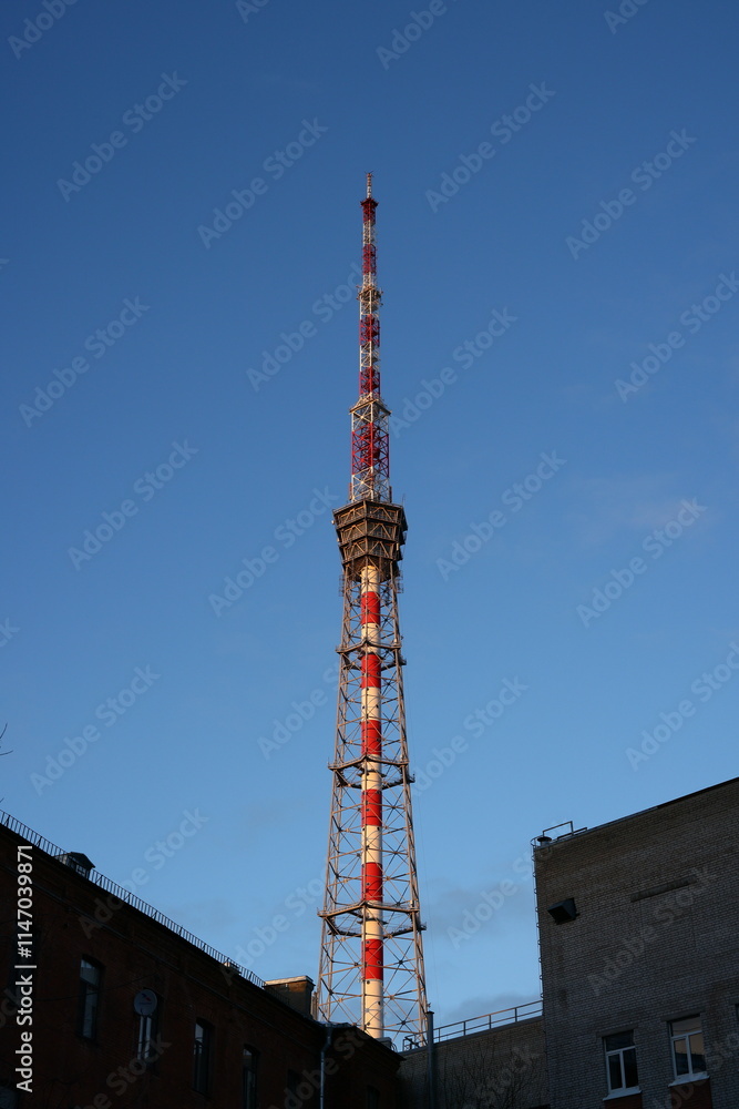 A Broadcast Tower Stands Tall Against a Bright Clear Blue Sky, Symbolizing Modern Communication A Broadcast Tower Stands Tall Against a Bright Clear Blue Sky, Symbolizing Modern Communication