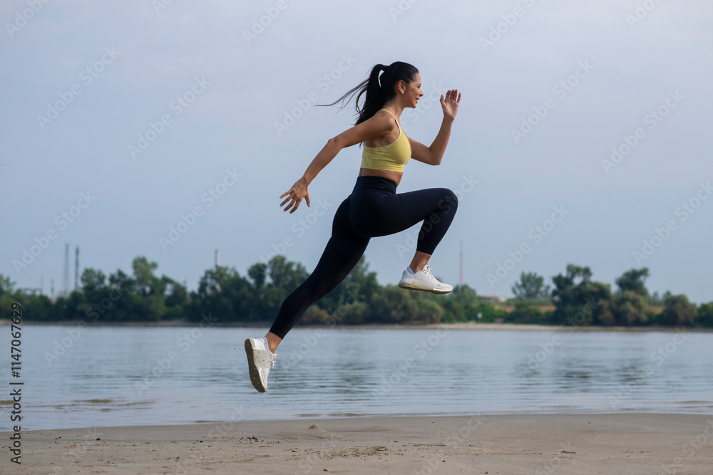 Woman exercising outdoors. An athlete makes jumps, does functional training on beach Woman exercising outdoors. An athlete makes jumps, does functional training on beach