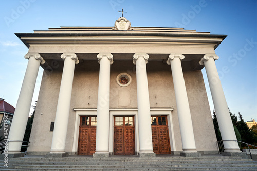 facade of a classicist catholic church with stairs and columns in the city of Poznan photo