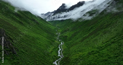 Aerial footage of beautiful high altitude grassland and mountain landscape