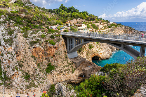 Scenic inlet called Ciolo, with bathers and a concrete bridge, in the municipality of Gagliano del Capo, province of Lecce, Salento area, Puglia region, Italy photo