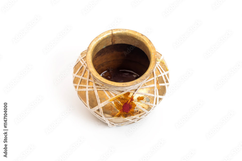 Traditional brass pot with white thread and ceremonial red mark, Closeup Traditional brass pot with white thread and ceremonial red mark, Closeup