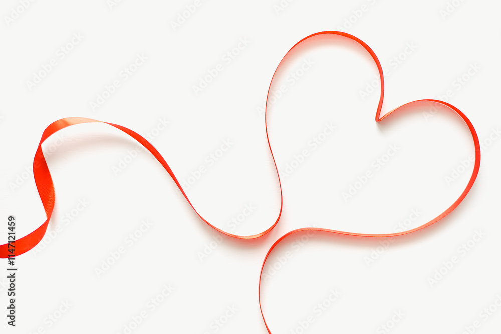 Heart made of satin ribbon on white background. Red heart on white background. Valentine's Day. Heart made of satin ribbon on white background. Red heart on white background. Valentine's Day.