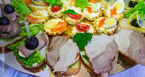 Gourmet appetizer platter with assorted sandwiches and hors d'oeuvres