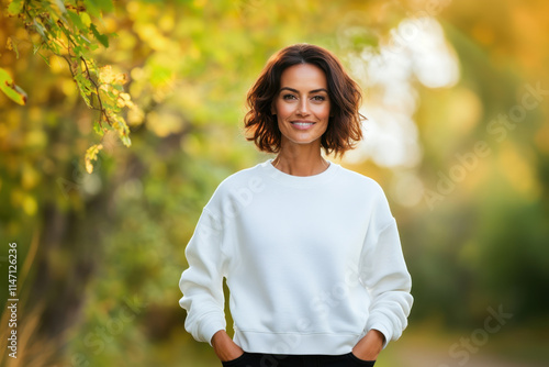 Middle aged woman wearing blank white sweatshirt mock up in nature. Mockup template of cotton sweatshirt with copy space for text design or logo photo