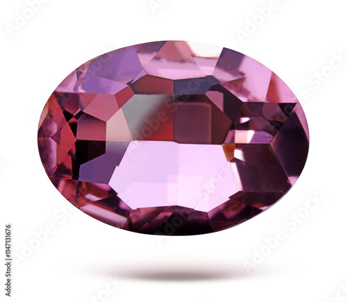 Pink shiny gemstone in air on white background photo