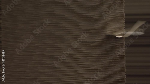 Wind flatters labels on cardboard stack in warehouse of finished products. Special building stores materials for further transportation to pick-up points