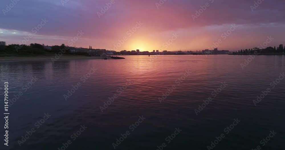 Newcastle Harbour during sunset after storm with purple, orange sky Newcastle Harbour during sunset after storm with purple, orange sky