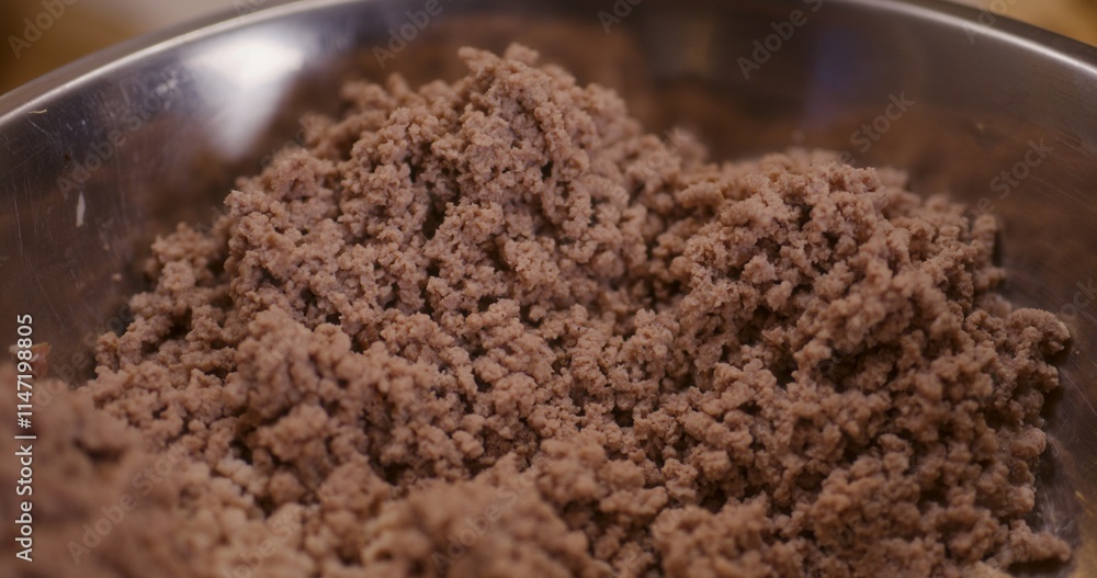 Macro shot of meat cooked and ground in meat grinder in bowl Macro shot of meat cooked and ground in meat grinder in bowl