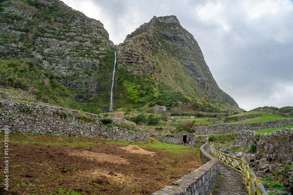 Fototapeta premium Pedestrian access path to the cascade of the codfish well on the island of flowers of the archipelago of the Azores