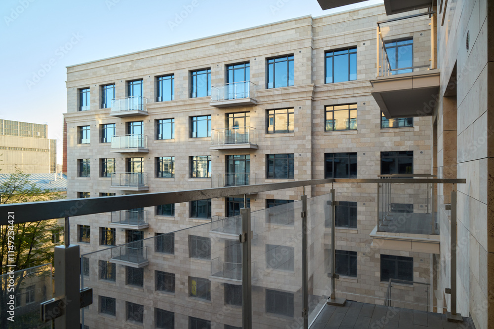 Fototapeta premium A modern apartment building featuring attractive balconies and sleek glass railings