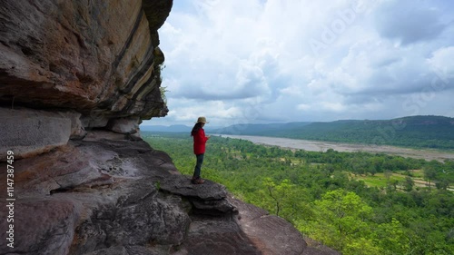 4k video,Female tourist walks around and taking photos at Pha Taem  national park. Ubon Ratchathani, Thailand