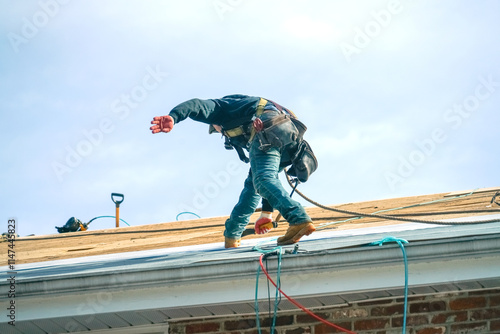 Wallpaper Mural worker install new shingle on the roof of the house for roof repair Torontodigital.ca