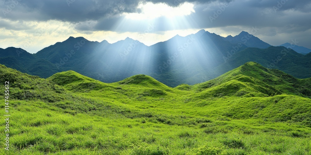 Fototapeta premium Breathtaking Sunlight Breaking Through Clouds Over Rolling Green Hills Mountainous Landscape Nature Serene Environment Wide-Angle View Tranquil Concept for Nature Lovers