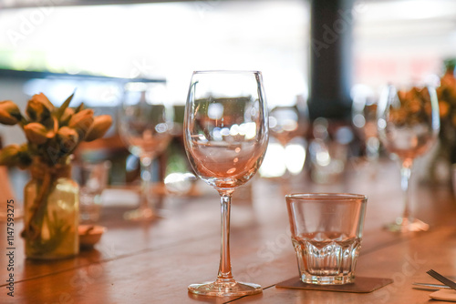 Table setting in restaurant ready for service with empty glasses photo