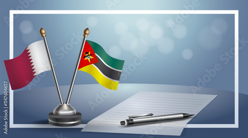 Qatar and Mozambique National flags on small table with bokeh background, cooperative relationship