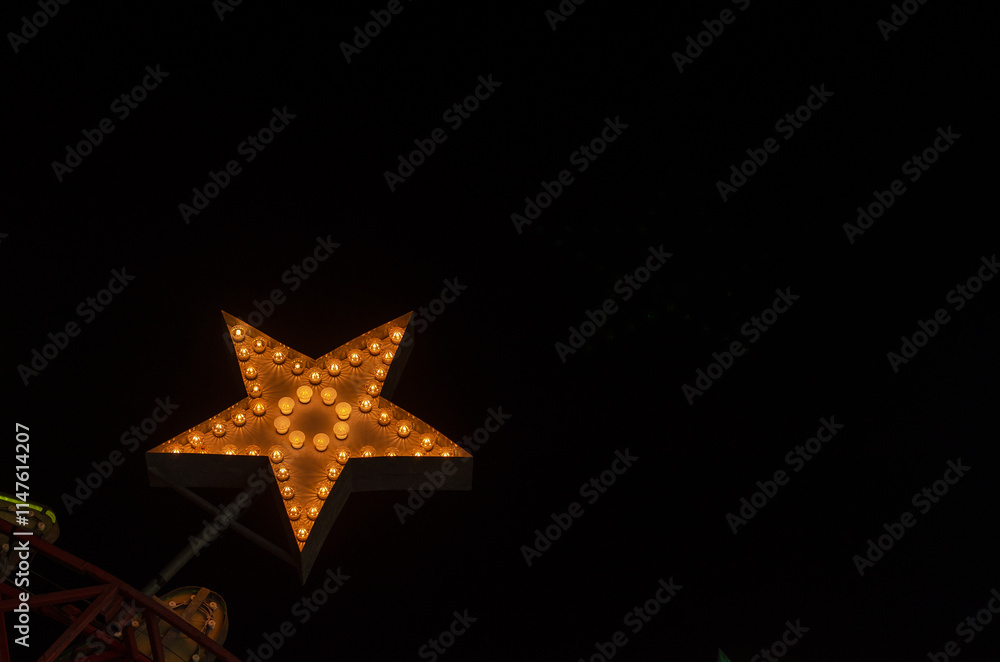 A large illuminated star against a dark background A large illuminated star against a dark background