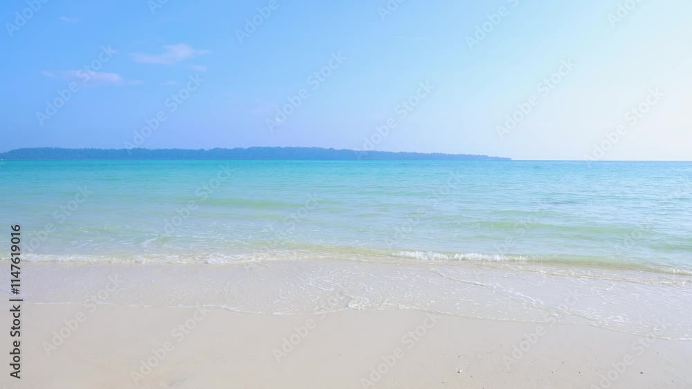 Pristine Coastal Scene with Rolling Waves on White Sand Beach and bright blue sky Pristine Coastal Scene with Rolling Waves on White Sand Beach and bright blue sky