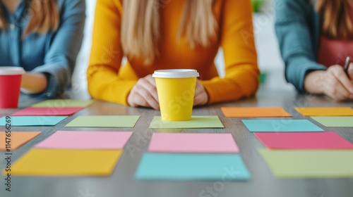 Business growth through expansion and branding concept Collaborative workspace with colorful sticky notes and a coffee cup in focus.