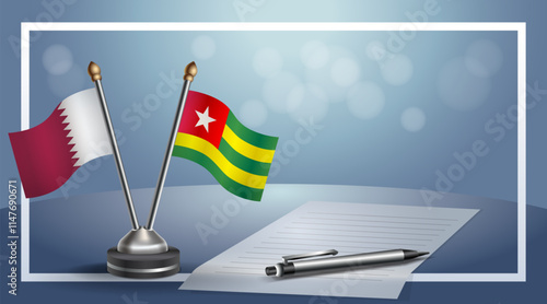 Qatar and Togo National flags on small table with bokeh background, cooperative relationship
