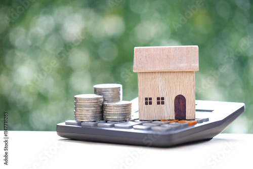 Estate tax,Model house on calculator with on natural green background,Business investment and Property tax concept