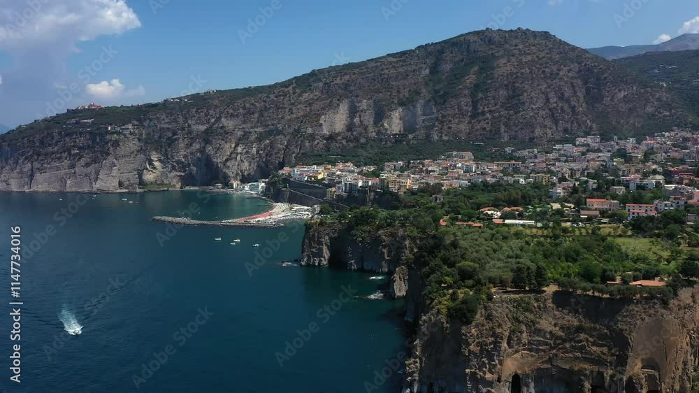 Aerial view from high altitude of Sorrento city coast, sea, beach and marina with ships and boats on sunny summer day, Italy, Europe Aerial view from high altitude of Sorrento city coast, sea, beach and marina with ships and boats on sunny summer day, Italy, Europe