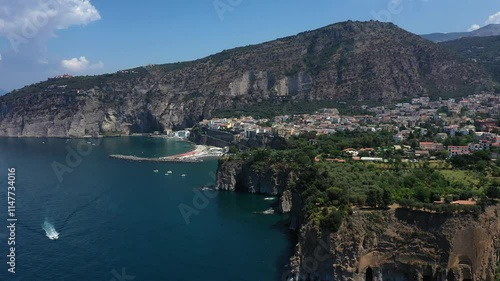 Aerial view from high altitude of Sorrento city coast, sea, beach and marina with ships and boats on sunny summer day, Italy, Europe