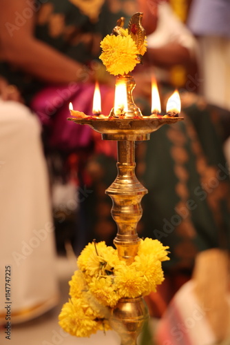 lighting of kuthu vilaku in south Indian tradition photo