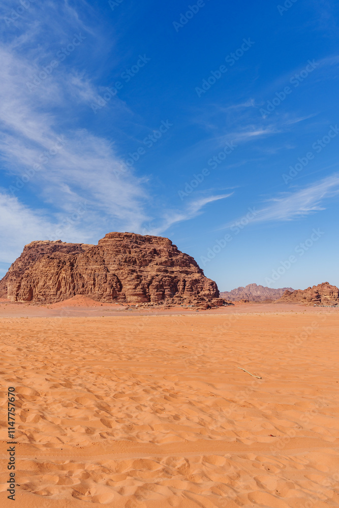 A stunning desert landscape featuring orange sand dunes, rugged rocky outcrops, and a vibrant blue sky adorned with delicate white clouds, showcasing the beauty and vastness of desert wilderness... A stunning desert landscape featuring orange sand dunes, rugged rocky outcrops, and a vibrant blue sky adorned with delicate white clouds, showcasing the beauty and vastness of desert wilderness...