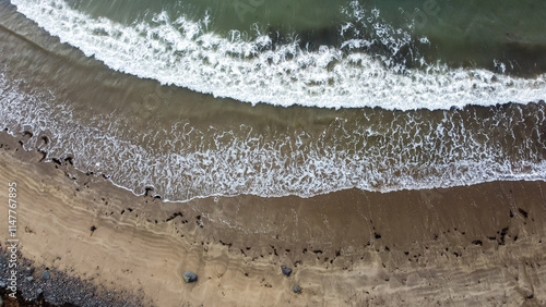 Aerial view of waves breaking on shoreline