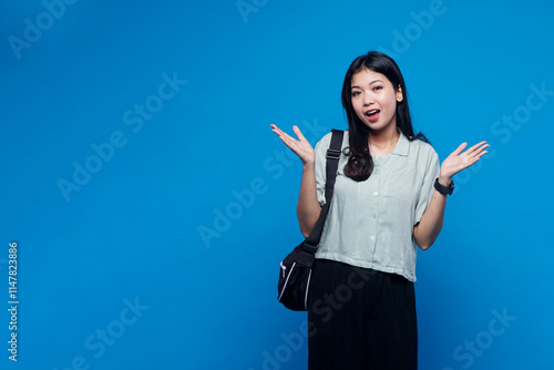 Happy casual potrait of young woman on blue background