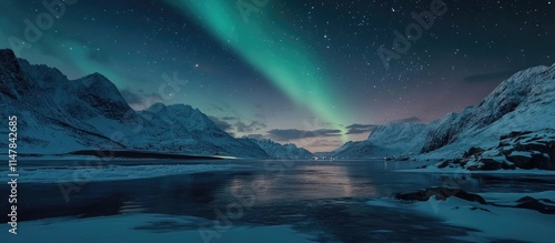 Northern lights over the snowy mountains, frozen sea, reflection in water at winter night in Lofoten, Norway. Aurora borealis and snowy rocks.