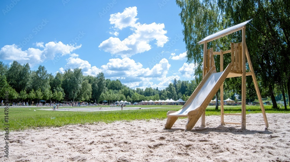 Fototapeta premium Wooden playground slide on sandy ground, sunny day.