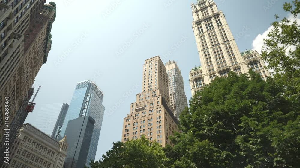 This photo showcases a blend of historic and modern architecture in Manhattan's financial district. Tall buildings rise above the greenery, creating a vibrant urban skyline. This photo showcases a blend of historic and modern architecture in Manhattan's financial district. Tall buildings rise above the greenery, creating a vibrant urban skyline.