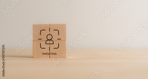 Customer targeting, marketing concept. Wooden blocks featuring a target icon with a human figure, symbolizing the concept of targeting, audience focus, precision in strategy. STP marketing model. photo