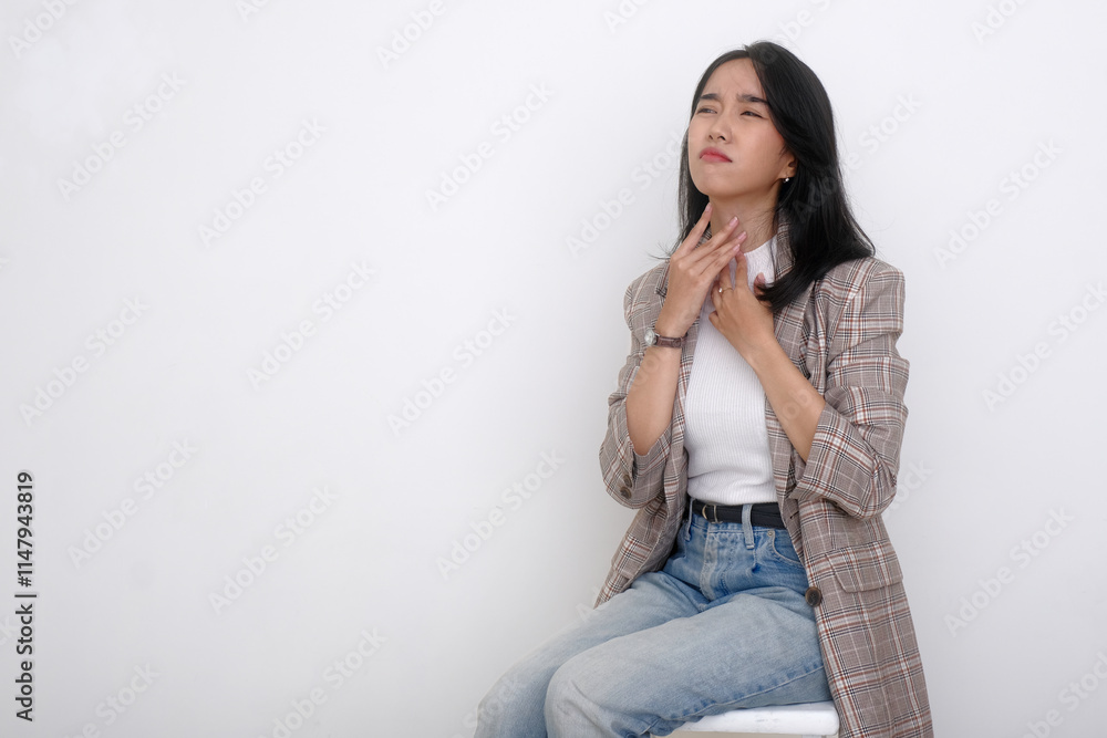 Young Indonesian woman feeling hard to breathe, suffering from a sore throat Young Indonesian woman feeling hard to breathe, suffering from a sore throat