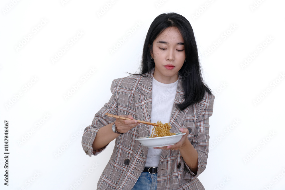 Asian young woman enjoying some homemade fried noodle using chopsticks Asian young woman enjoying some homemade fried noodle using chopsticks