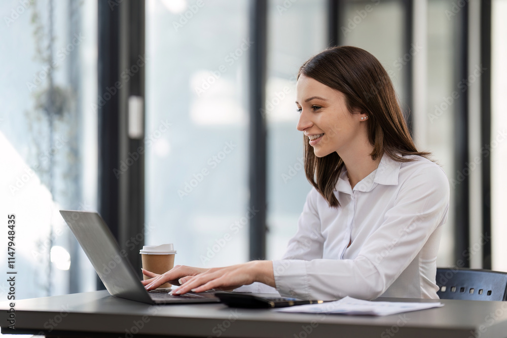 Professional Business Woman Working on a Desk with Laptop in Modern Office Environment Professional Business Woman Working on a Desk with Laptop in Modern Office Environment