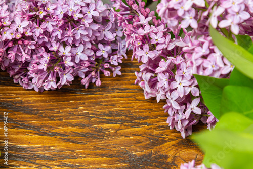 Beautiful spring flowers lilac on a wooden vintage board with place for text. Syringa vulgaris. Happy Mother's Day greetings card.