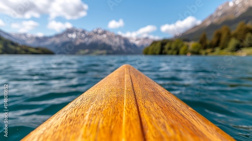 A view from the bow of a canoe on a lake with mountains in the background photo